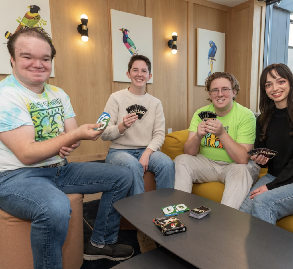 A group of four people playing cards