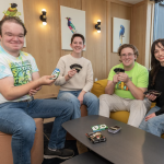 A group of four people playing cards