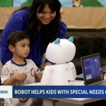 A mother and child engage with a small white robot with cat ears