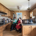 Ellen and Emily Ladau in their kitchen modified for their power chairs