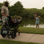 Conlan Armour stands next to his son, Cayden. Conlan's fiancee Dorothy Newton plays with their infant daughter