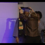 A student from the 1950s Kendall school has a mortar board placed on their head during a ceremony at Gallaudet University