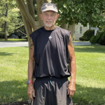 Jerry Lechliter standing in athletic clothing in front of a tree