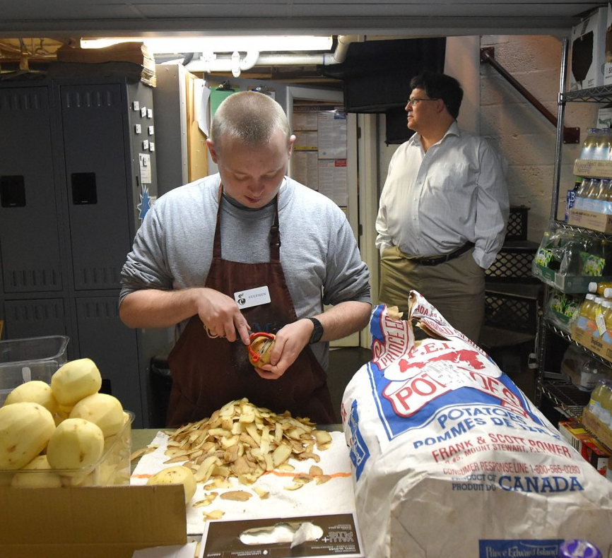 Stephen Wittstadt, who has autism, peels potatoes at Sam's Caterbury Cafe in Baltimore