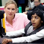 Mary Anne Terzaghi watches Sehaj Kaur access her new eyegaze device